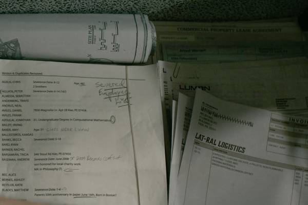 The bottom compartment contains site plans and several other documents, including invoices